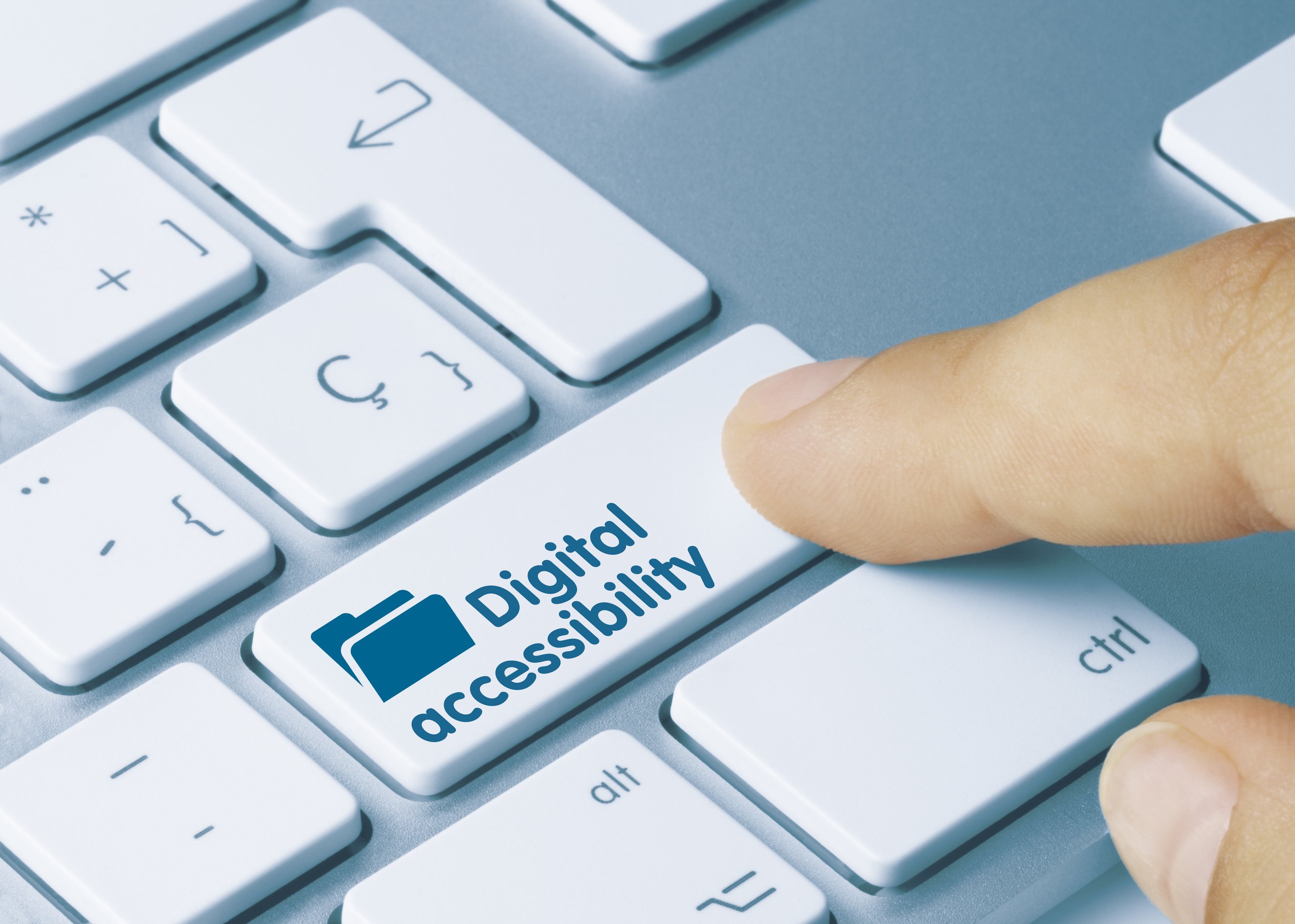 Close-up of a computer keyboard with a finger pressing a key labeled “Digital accessibility,” featuring a folder icon, symbolizing access to inclusive digital content and tools.