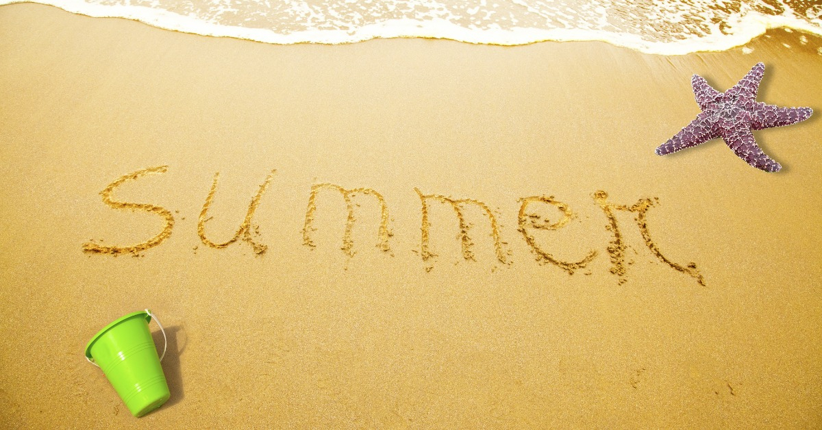 Summer Written in Sand on Beach with a sea star and a toy bucket