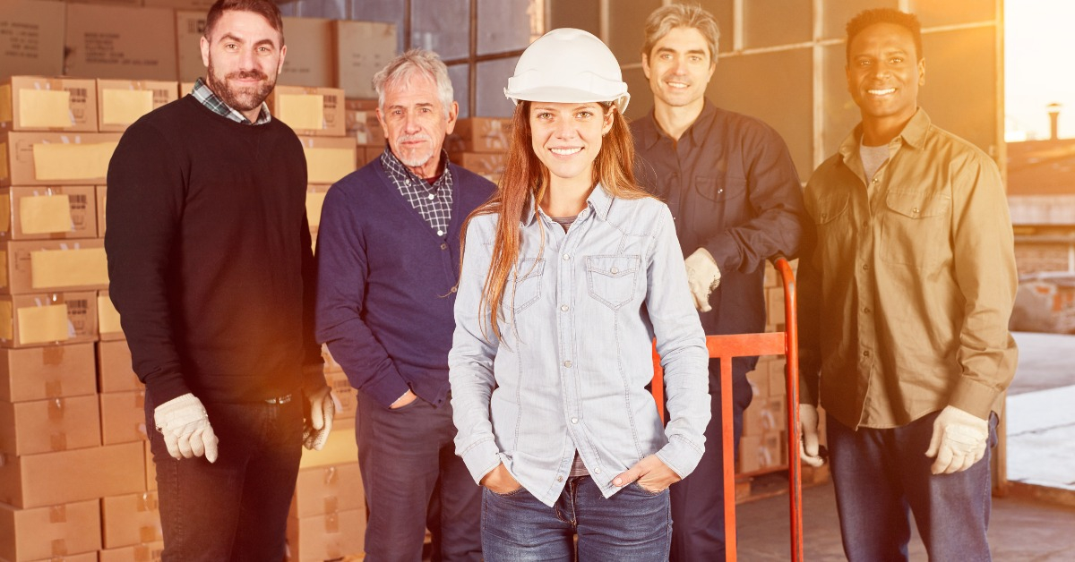 Woman is training as a warehouse worker in forwarding in front of a team