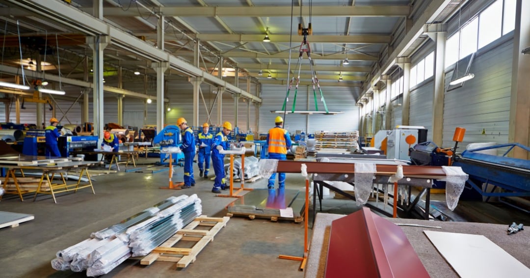 Workers in manufacturing workshop at plant of Group of companies