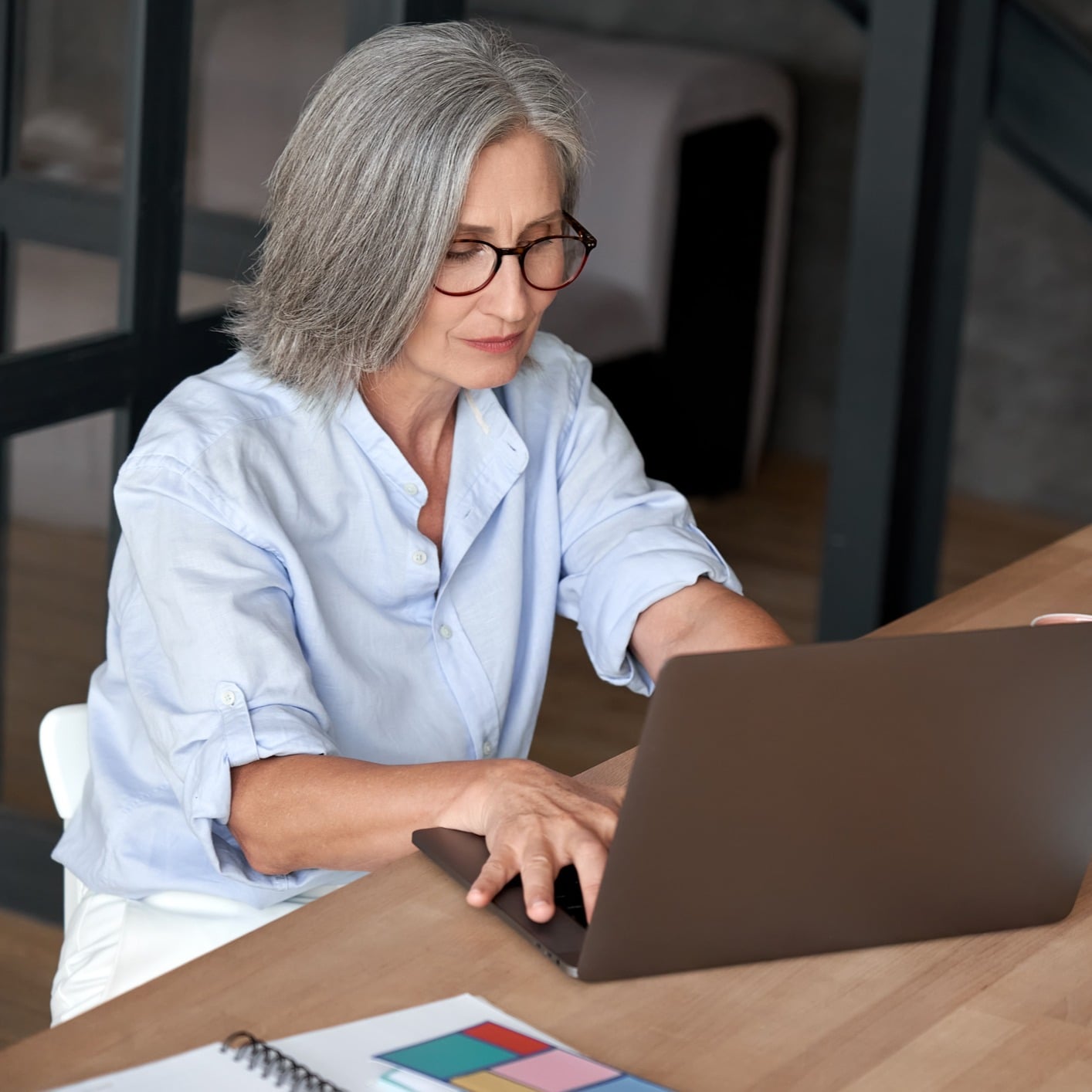 A woman works on a laptop