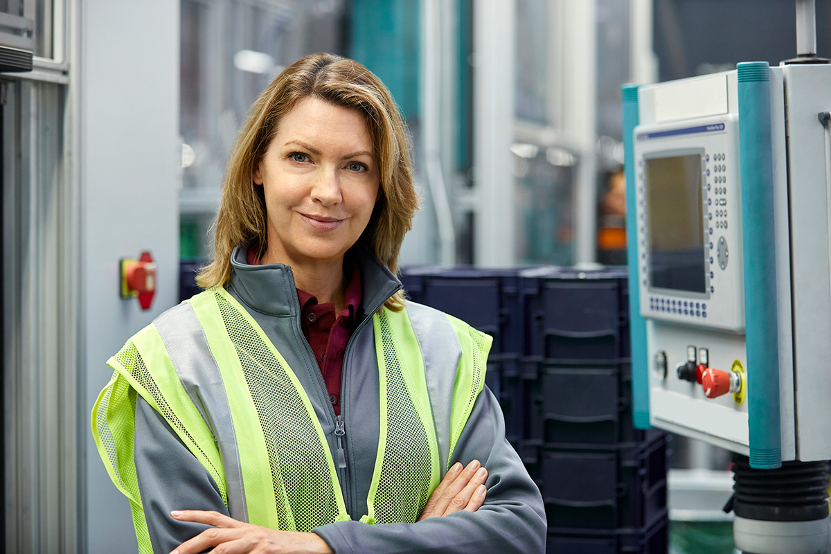 GettyImages-955959536-Portrait of female engineer by control panel in automobile industry.